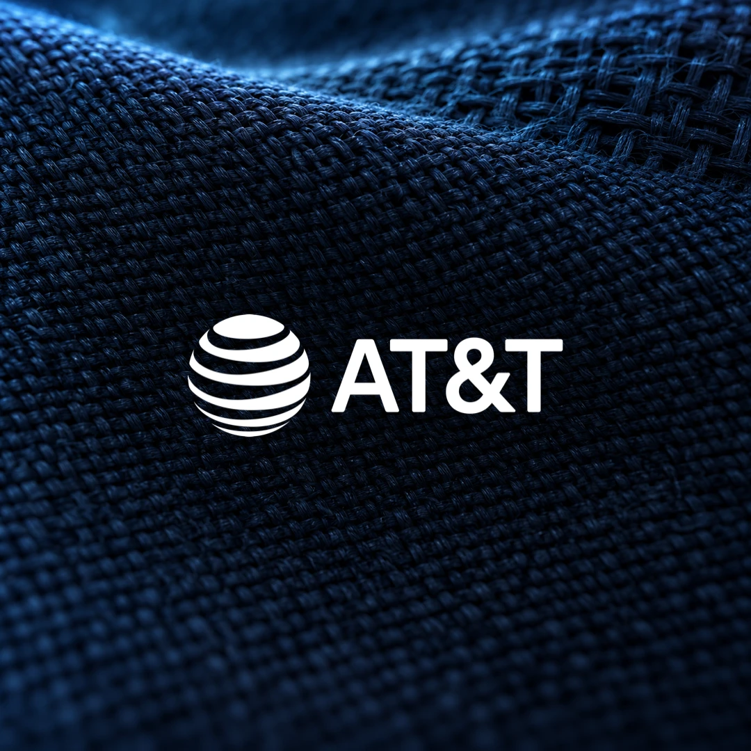 White AT&T logo centered over a dark blue woven textile.